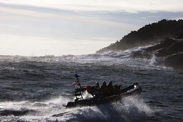 Baltimore Atlantic 75 inshore lifeboat Bessie B-708, waves breaking agasint rocks in the background