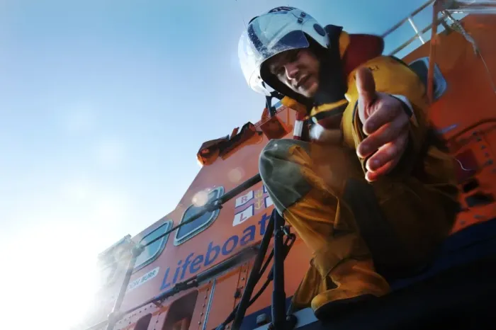 Framed Print : Crew member onboard Portrush Severn class lifeboat William Gordon Burr 17-30 reaching down towards the camera with hand extended Framed Print : Crew member onboard Portrush Severn class lifeboat William Gordon Burr 17-30 reaching down towards the camera with hand extended