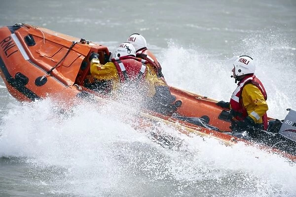 Eastbourne D-class inshore lifeboat Joan and Ted Wiseman 50 D-605. Close up shot, lifeboat moving from right to left, lots of white spray
