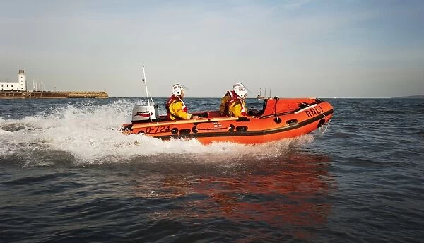 Exercise between Scarborough D-class inshore lifeboat and lifeguards. D-class John Wesley Hillard III D-724 lifeboat moving from left to right