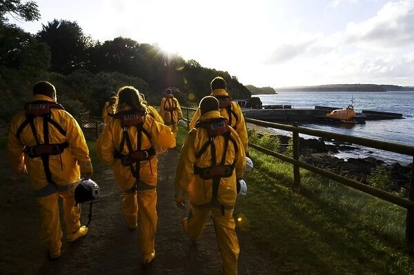 Group shot of the Tenby crew members walking along towards the Tamar class lifeboat Haydn Miller 16-02 in the distance