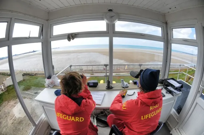 Framed Print : Two lifeguards monitoring the sea at a beach in Jersey from lifeguard hut Framed Print : Two lifeguards monitoring the sea at a beach in Jersey from lifeguard hut