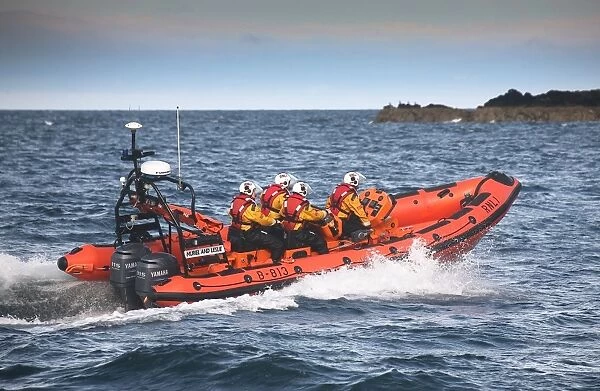 Port Erin Atlantic 85 class inshore lifeboat Muriel and Leslie B-813. Lifeboat heading from left to right, four crew on board