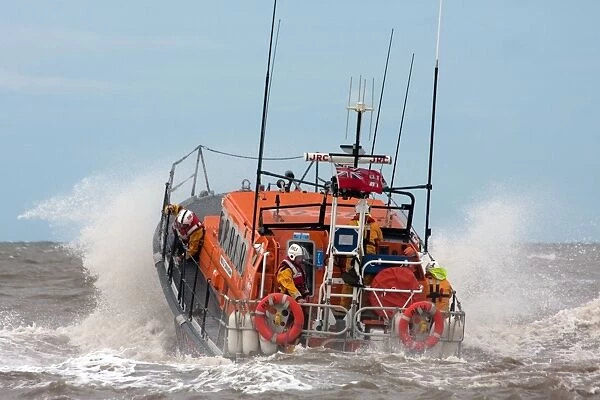 Rhyl Mersey class lifeboat Lil Cunningham 12-24. Lifeboat being launched through breaking wave, crew on baord