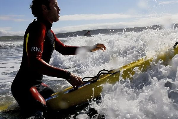 An RNLI lifeguard on a paddleboard at Woolacombe