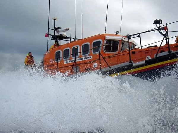 Swanage mersey class lifeboat Robert Charles Brown 12-23. Lots of white spray, crew member stood at the stern