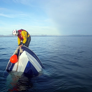 Abersoch crew member on board a sinking vessel. The crew member is attaching a buoy to alert shipping in the area. Second place in the Photographer of the Year 2012