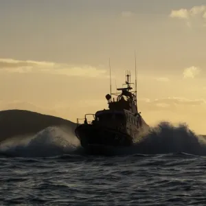 Achill Island trent class lifeboat Sam and Ada Moody 14-28. Lifeboat is heading towards the camera, silhouetted against a dramatic sky Achill Island trent class lifeboat Sam and Ada Moody 14-28. Lifeboat is heading towards the camera, silhouetted against a dramatic sky