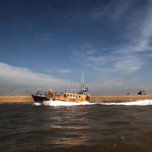 Aldeburgh mersey class lifeboat Freddie Cooper 12-34 moving from right to left, lighthouse in the background