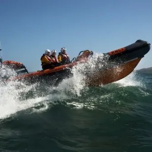 Baltimore Atlantic 75 inshore lifeboat Bessie B-708 moving from left to right, bow high out of the water, lots of white spray Baltimore Atlantic 75 inshore lifeboat Bessie B-708 moving from left to right, bow high out of the water, lots of white spray