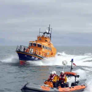 Bangor Atlantic 21 ILB B-584 Youth of Ulster alongside Donaghadee Trent class ALB 14-36 Saxon. Grey day with sea spray to the bows of the lifeboats. Crew visible on the upper steering position on the Trent and on the Atlantic 75