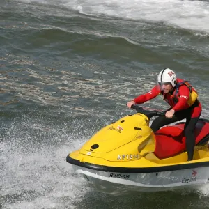 Two beach lifeguards on a rescue water craft