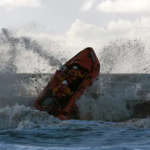 Blackpool D-class inshore lifeboat D-729 launching through a breaking wave