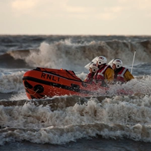 Blackpool D-class inshore lifeboat D-729 in surf, three crew on board
