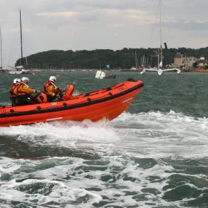 Cowes Atlantic 85 inshore lifeboat Tabbycat B-810 moving from left to right at speed during a demonstration at Cowes Week