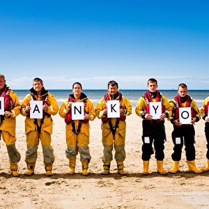 Crew members at Rhyl holding up letters spelling out the words Thank You. Left to right: Paul Frost MBE (Deputy 2nd coxswain / LPO), Derek Denton (Tractor drive / ALB crew), Bob Baines (Tractor driver / ALB crew), Tina Elliot (ALB crew)