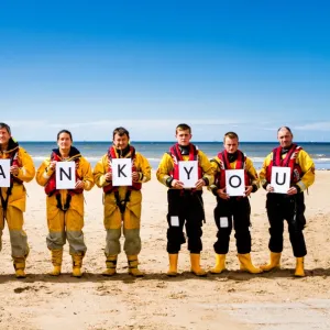 Crew members at Rhyl holding up letters spelling out the words Thank You. Left to right: Paul Frost MBE (Deputy 2nd coxswain / LPO), Derek Denton (Tractor drive / ALB crew), Bob Baines (Tractor driver / ALB crew), Tina Elliot (ALB crew)