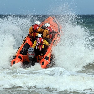 Cromer D-class inhsore lifeboat George and Muriel D-734 heading through a breaking wave following her naming ceremony