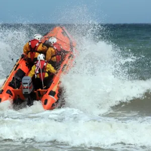 Cromer D-class inhsore lifeboat George and Muriel D-734 heading through a breaking wave following her naming ceremony