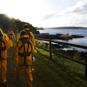 Group shot of the Tenby crew members walking along towards the Tamar class lifeboat Haydn Miller 16-02 in the distance