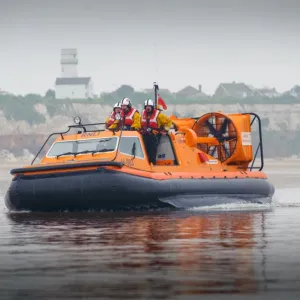 Hunstanton hovercraft The Hunstanton Flyer H-003 heading from right to left over mudflats, four crew on board