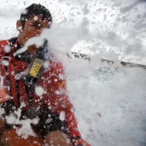 Lifeguard at the helm of an arancia inshore rescue boat at Constantine Bay, Cornwall