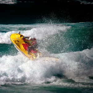 Lifeguard on a rescue watercraft (RWC) in the surf at Perranporth beach, Cornwall