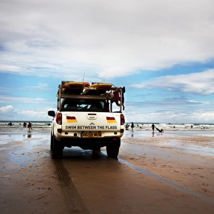 Lifeguards monitoring the beach from a patrol vehicle
