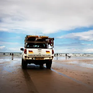 Lifeguards monitoring the beach from a patrol vehicle