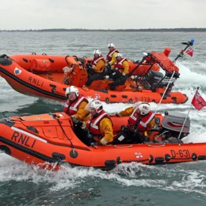 Littlehampton Atlantic 75 Blue Peter I. Three crew on board, lifeboat moving from right ot left in background. In foreground, D-class inshore lifeboat Spirit of Juniper D-634