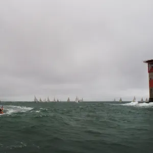 Lymington Atlantic 75 inshore lifeboat Victor Danny Lovelock B-784 during the Round the Island Race 2011. Racing yachts and the Needles lighthouse in the distance