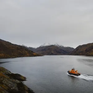 Mallaig severn class lifeboat Henry Alston Hewat 17-26 at sea, snow capped mountains in the background