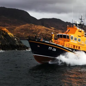 Mallaig severn class lifeboat Henry Alston Hewat 17-26. Lifeboat in the distance moving from right to left, hills and cliffs behind