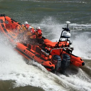 Minehead Atlantic 85 inshore lifeboat Richard and Elizabeth Deaves B-824. Lifeboat heading from away from the camera, four crew on board, lots of white spray