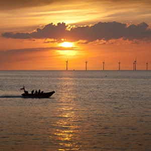 New Brighton Atlantic 85 inshore lifeboat B-837 Charles Dibdin on way to a rescue in Crosby on the other side of the River Mersey at sunset. The windfarm in the background is in Liverpool Bay. Shortlisted finallist for Photographer of the Year 2012