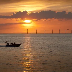 New Brighton Atlantic 85 inshore lifeboat B-837 Charles Dibdin on way to a rescue in Crosby on the other side of the River Mersey at sunset. The windfarm in the background is in Liverpool Bay. Shortlisted finallist for Photographer of the Year 2012