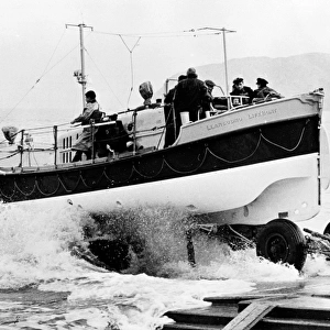 Oakley twin motor lifeboat Lilly Wainwright ON 976, Llandudno. Lifeboat being launched from trailer on slipway. Scanned from negative 193