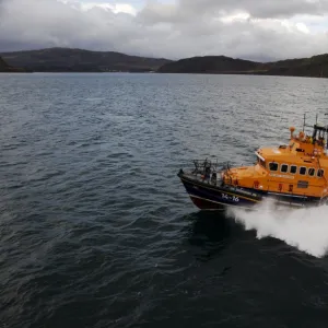 Portree trent class lifeboat Stanley Watson Barker 14-16 moving from right to left, crew on the stern and upper steering position