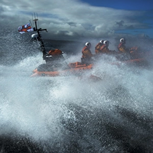 Red Bay Altantic 85 inshore lifeboat Geoffrey Charles B-843. Lifeboat moving from left to right at speed, four crew on board, lots of white spray