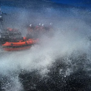 Red Bay Altantic 85 inshore lifeboat Geoffrey Charles B-843. Lifeboat moving from left to right at speed, four crew on board, lots of white spray Red Bay Altantic 85 inshore lifeboat Geoffrey Charles B-843. Lifeboat moving from left to right at speed, four crew on board, lots of white spray