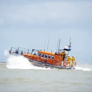 Relief Mersey class lifeboat Mary Margaret 12-28 at Eastbourne. Lifeboat moving from right to left, crew at the stern Relief Mersey class lifeboat Mary Margaret 12-28 at Eastbourne. Lifeboat moving from right to left, crew at the stern
