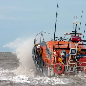 Rhyl Mersey class lifeboat Lil Cunningham 12-24. Lifeboat being launched through breaking wave, crew on baord