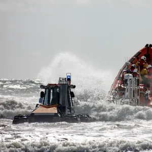 St Bees Atlantic 85 class inshore lifeboat Joy Morris MBE B-831 being launched from a trailer in rough seas. Four crew on board, bow high out of the water