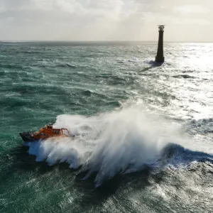 St Marys Severn class lifeboat 17-11 in rough seas off the lighthouse at Bishops Rock, the westnermost point of the Isles of Scilly