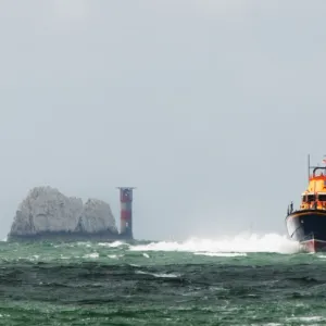 Yarmouth Severn class lifeboat Eric and Susan Hiscock (Wanderer) 17-25 providing safety cover during the Round the Island Race. The Needles lighthouse in the foreground