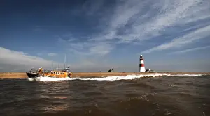 Aldeburgh mersey class lifeboat Freddie Cooper 12-34 moving from right to left, lighthouse in the background