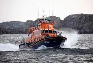 Arranmore severn class lifeboat Mrytle Maud 17-22 moving from left to right at speed, cliffs in the distance