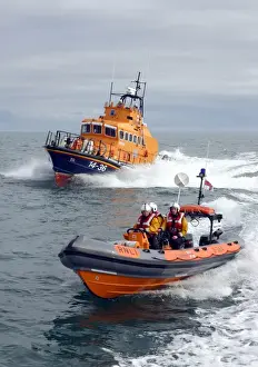 Bangor Atlantic 21 ILB B-584 Youth of Ulster alongside Donaghadee Trent class ALB 14-36 Saxon. Grey day with sea spray to the bows of the lifeboats. Crew visible on the upper steering position on the Trent and on the Atlantic 75
