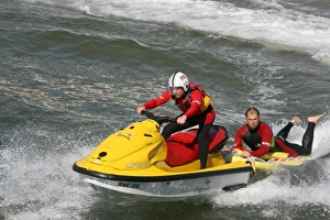 Two beach lifeguards on a rescue water craft