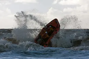 Blackpool D-class inshore lifeboat D-729 launching through a breaking wave